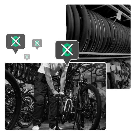 bicycle repairer inflating a bike tyre and stored tyres